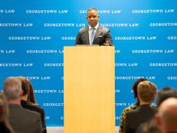 Assistant Attorney General Kenneth A. Polite Jr. speaks from a podium to students, staff, and attorneys at Georgetown Law.