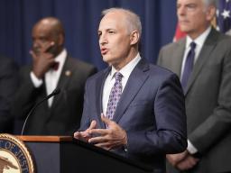 Assistant Attorney General Matthew G. Olsen of the Justice Department's National Security Division delivers remarks from a podium bearing the Department of Justice seal
