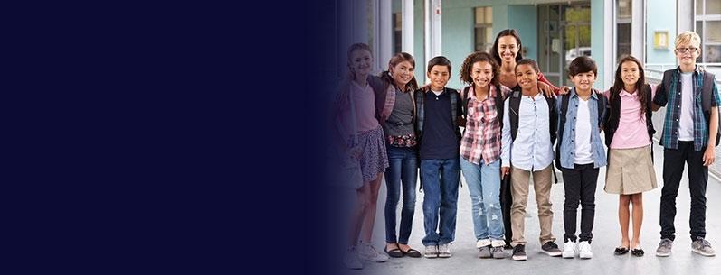 A teacher and her students outside of a school building