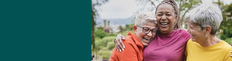 Happy multiracial senior women having fun together at park.