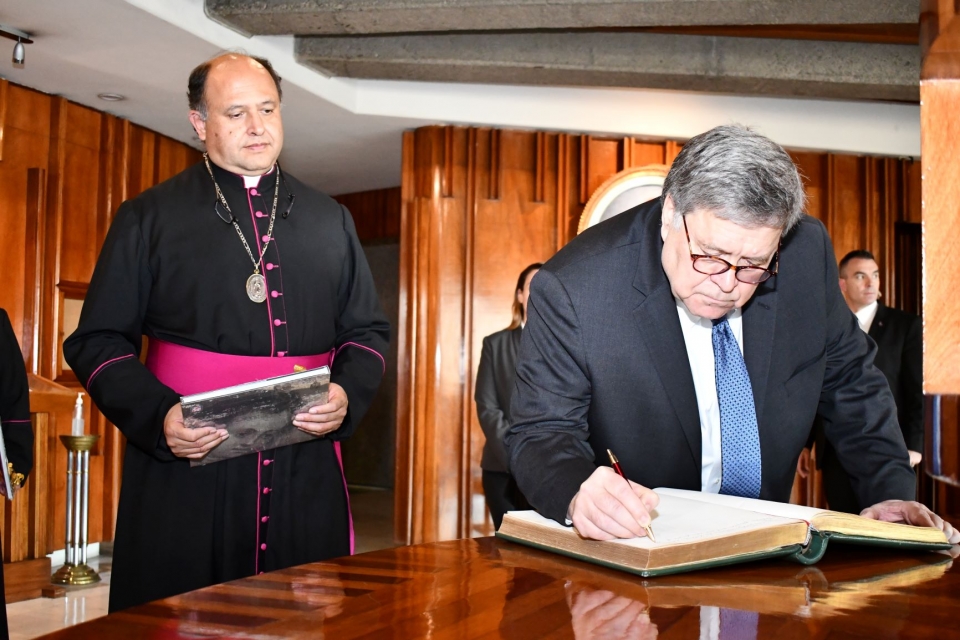 Attorney General Barr signs the guest book at the Basilica of Our Lady of Guadalupe