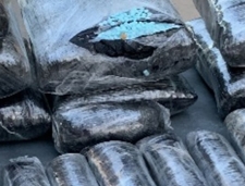 Close up of one of the hidden packages cut open containing blue pills stamped M30 Close up of one of the 21 packages discovered by Pinal County deputies. The package is cut open revealing blue pills stamped M30. The package was hidden underneath the rear seat floorboard.