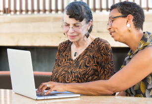 Two older women looking at a laptop