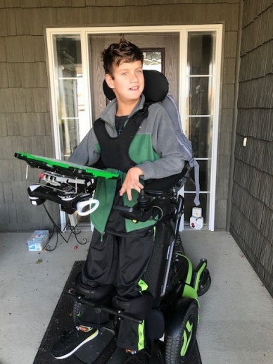 Isaiah on the Porch Isaiah pictured on a porch in front of a door in a wheel chair