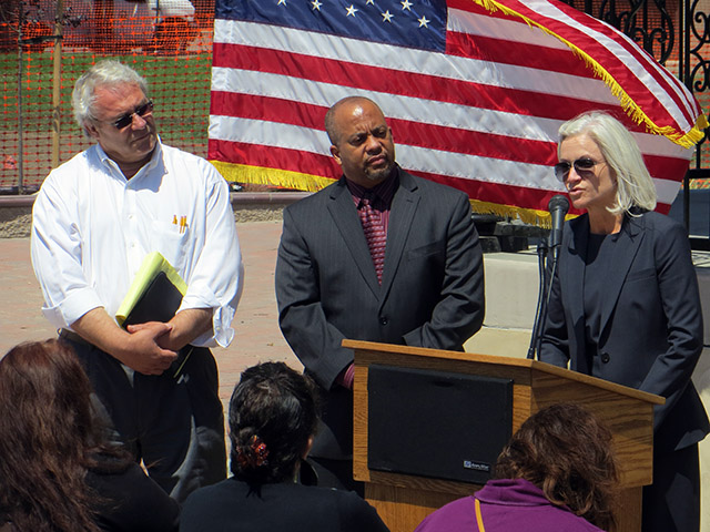 Salinas Mayor Dennis Donohue (left) and United States Department of Justice liaison Gregory Joy listen as U.S. Attorney Melinda Haag speaks in Closter Park