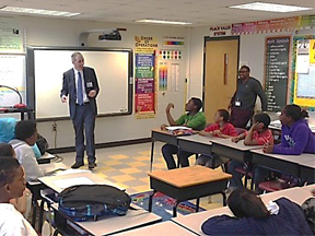 Assistant U.S. Attorney Paul Jones (L) speaking to Bethune Elementary School students in Atlanta, Ga.