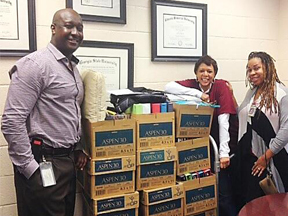 Assistant U.S. Attorney and Community Outreach Coordinator Loranzo M. Fleming with Hope-Hill Counselor receiving boxes of school supplies.